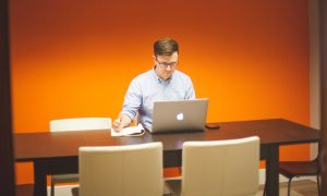 Man creating powerpoint presentation on mac