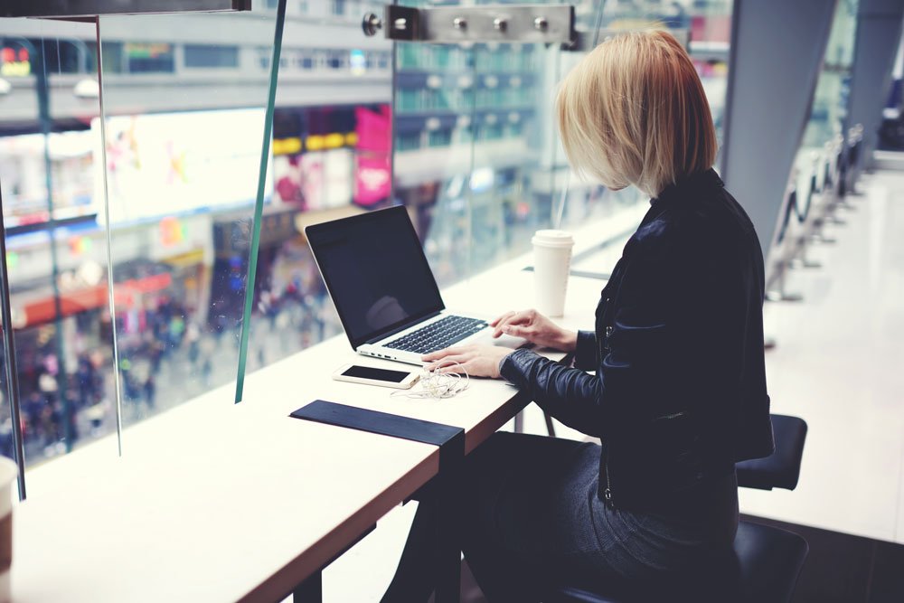 woman doing last minute amends to presentation in coffee shop