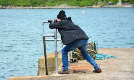 Photographer at harbour searching for the perfect image
