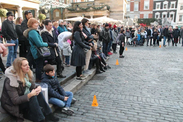 attentive audience watching street performer