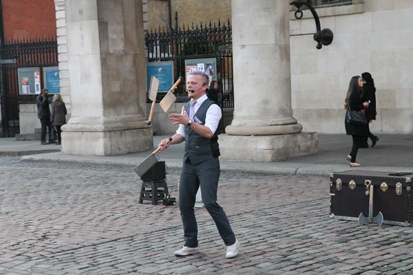 Street performer juggling meat cleavers