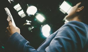 presenter reading a script on stage