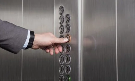 male hand pressing button on elevator