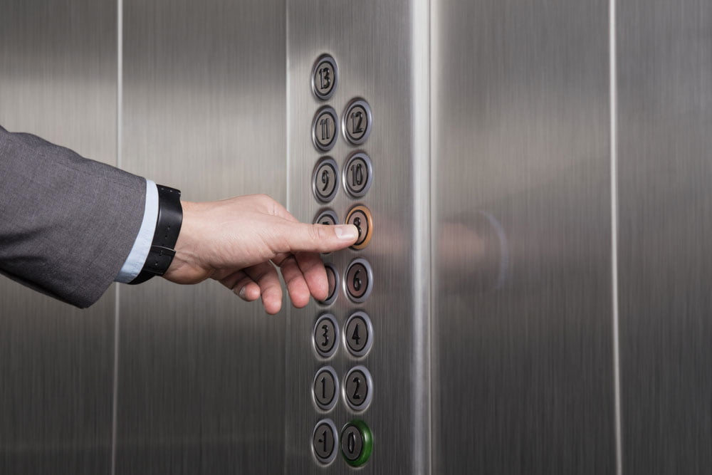 male hand pressing button on elevator