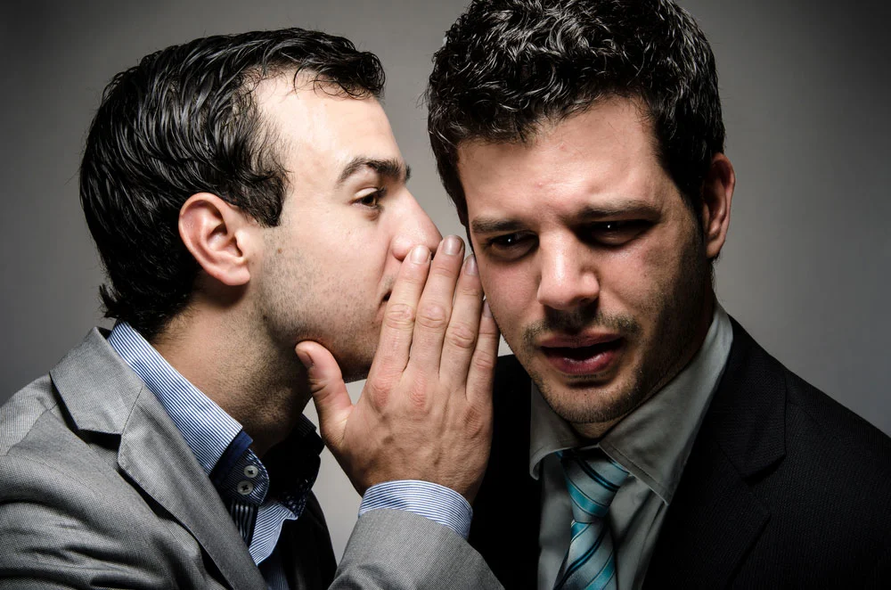 whispering a secret to a nervous speaker