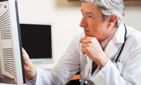 doctor looking at presentation on computer screen