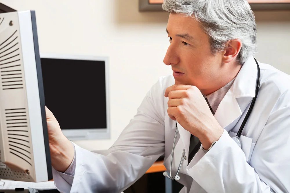 doctor looking at presentation on computer screen