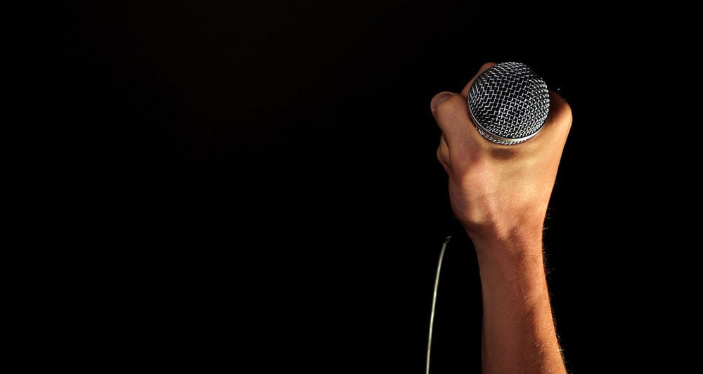 presenter holding microphone to start speech