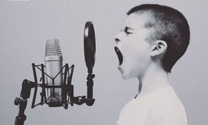 young person shouting into microphone