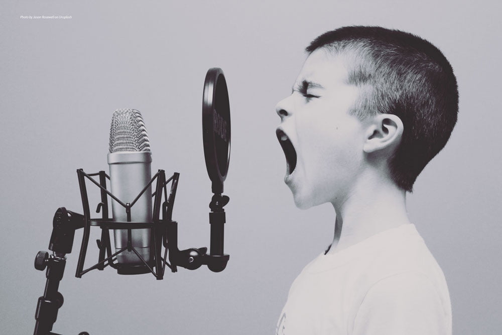 young person shouting into microphone