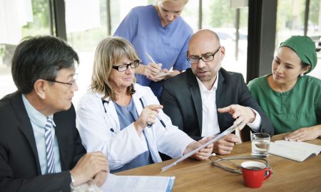 Healthcare professionals having team briefing