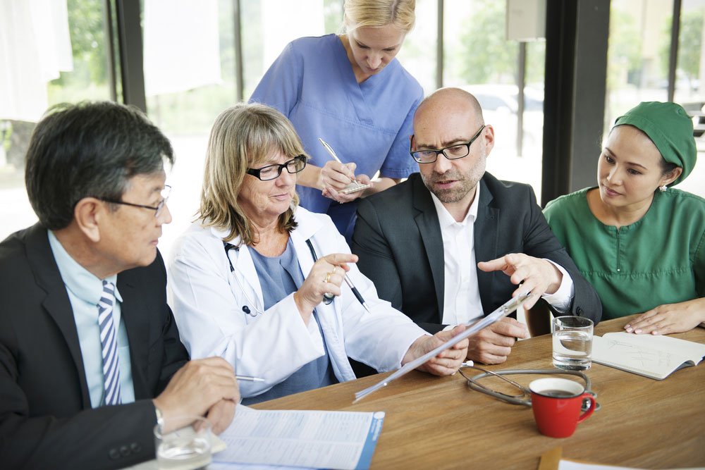 Healthcare professionals having team briefing