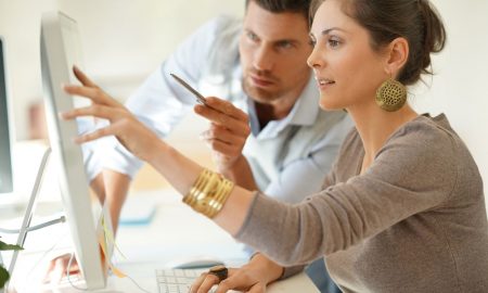 Couple working on presentation at desktop computer