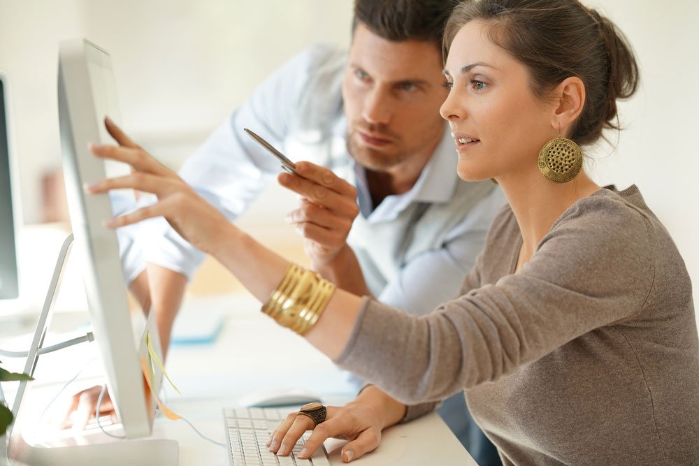 Couple working on presentation at desktop computer