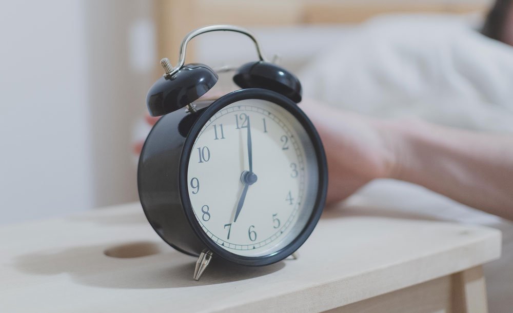 alarm clock beside bed