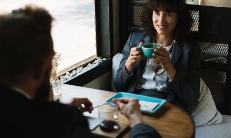 2 business people having conversation over coffee