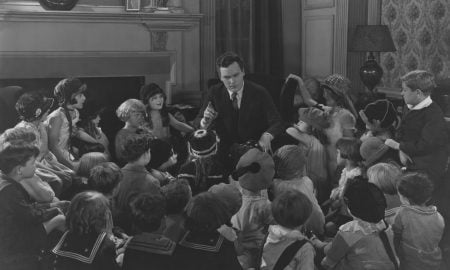 Storyteller with large group of children