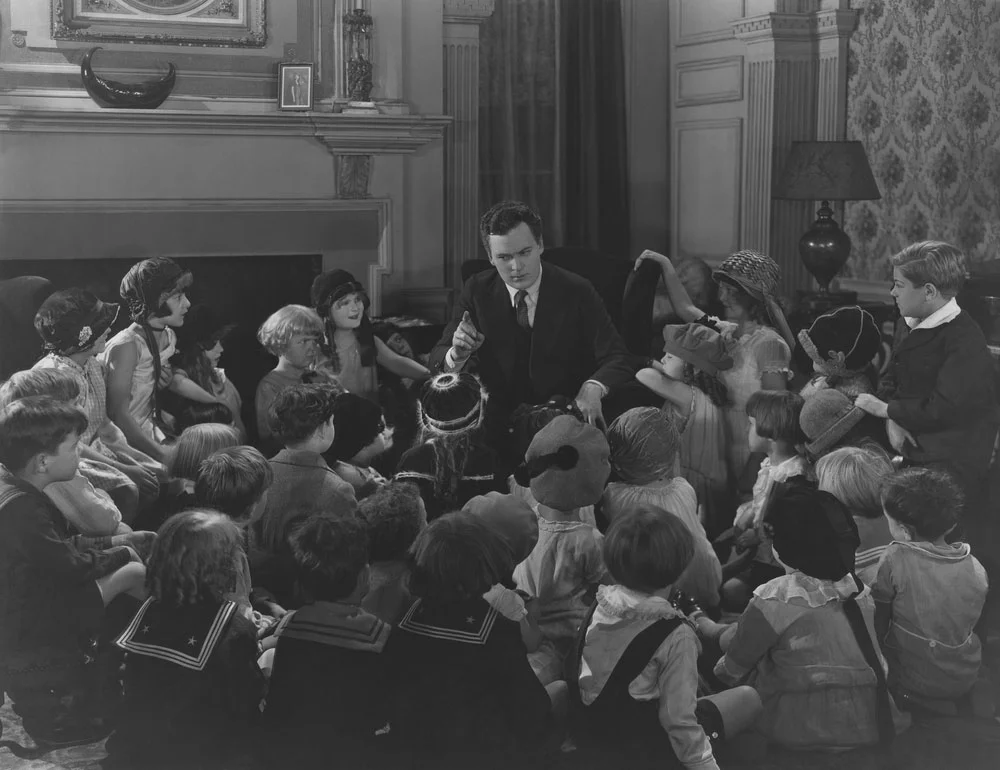 Storyteller with large group of children