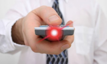 presenter in white shirt point presentation remote control with red laser light