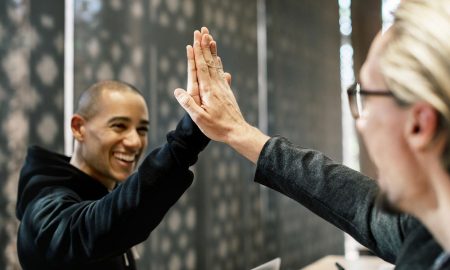 young man and older lady high fiving each other