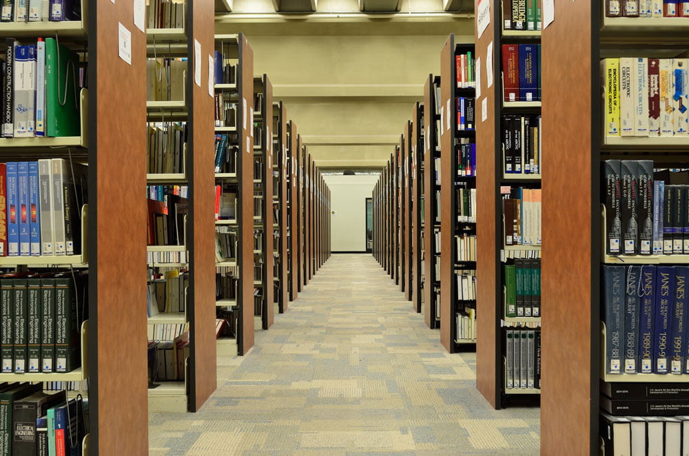 rows of bookcases in public library