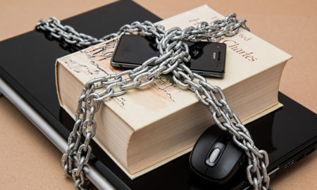 laptop book and iphone tied together with heavy duty chain to protect them